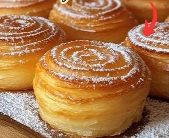 Freshly baked cruffins with a golden flaky exterior and sweet filling