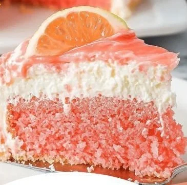 Slice of Hawaiian Guava Cake with vibrant guava frosting and tropical decorations