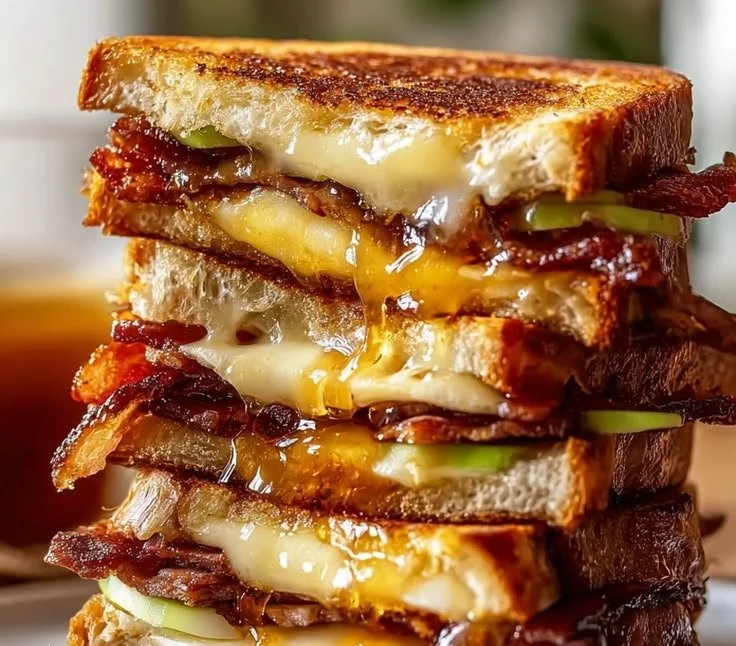 Hot Honey Apple Cheddar Beef Bacon Grilled Cheese Sandwich with melted cheese