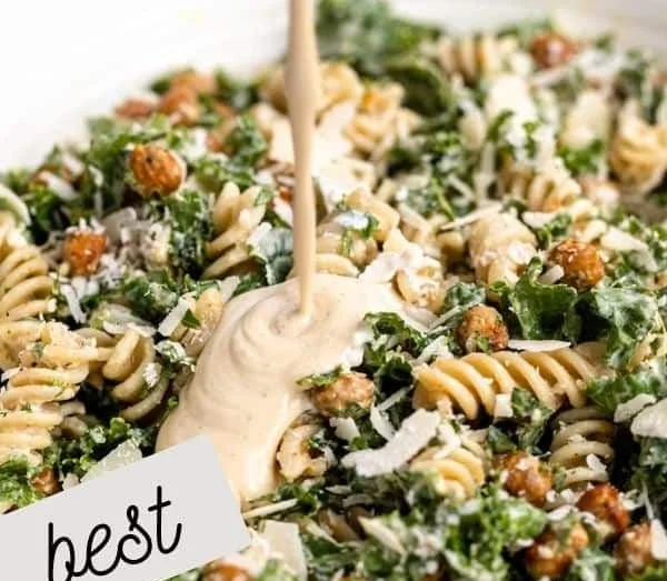 Bowl of Kale Caesar Pasta Salad with fresh ingredients and creamy dressing