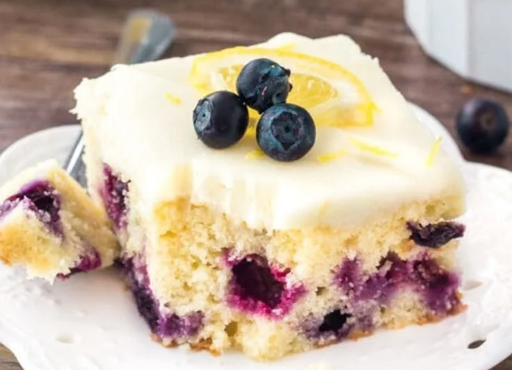 A delicious Lemon Blueberry Cake topped with fresh blueberries and lemon zest.