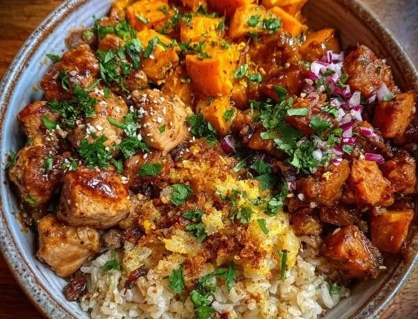 Maple Dijon Chicken and Sweet Potato Bowl garnished with herbs