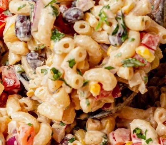 Bowl of colorful Mexican macaroni salad with fresh ingredients and vibrant spices
