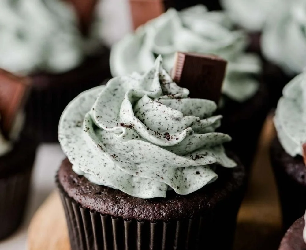 Deliciously decorated mint chocolate cupcakes topped with mint frosting.