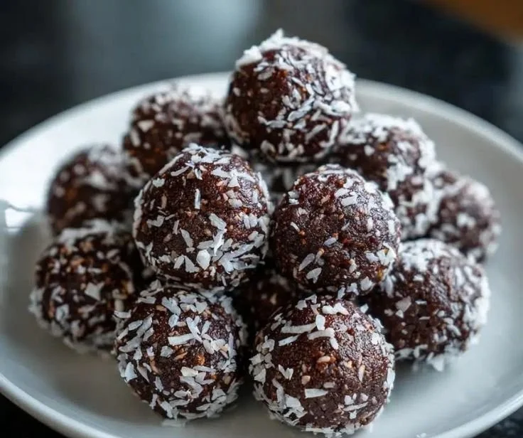 Plate of no-bake chocolate balls ready to eat in 20 minutes.