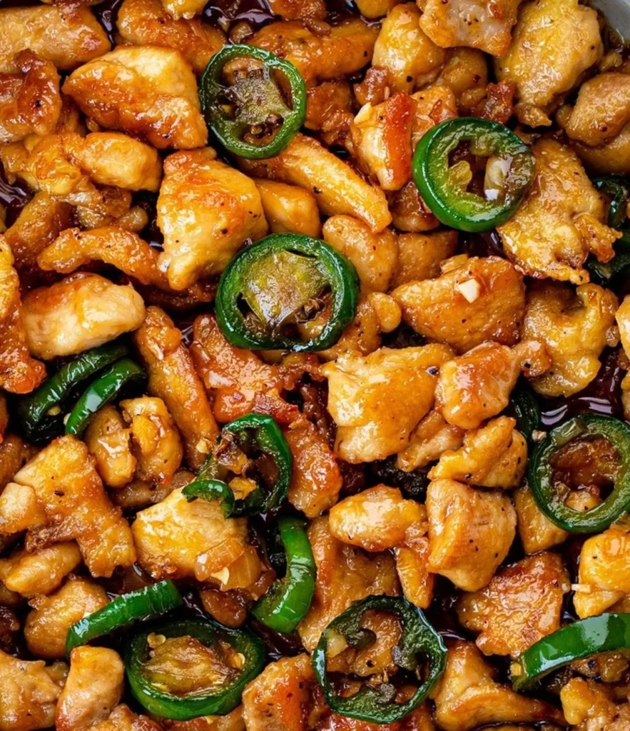 Delicious Spicy Jalapeño Chicken garnished with fresh jalapeños and herbs