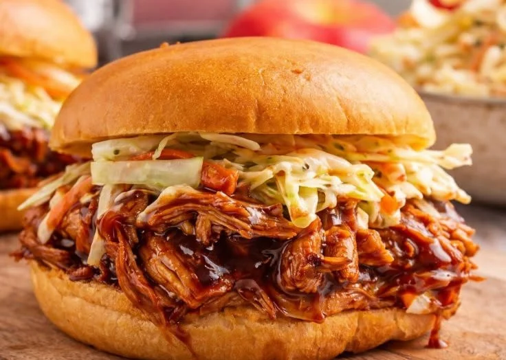Delicious BBQ pulled chicken served on a bun with coleslaw