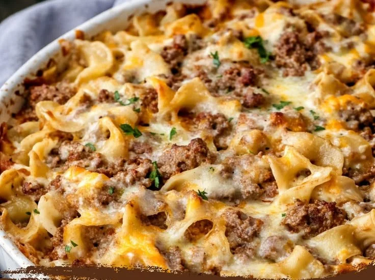 Delicious beef noodle casserole topped with sour cream, perfect for family meals.