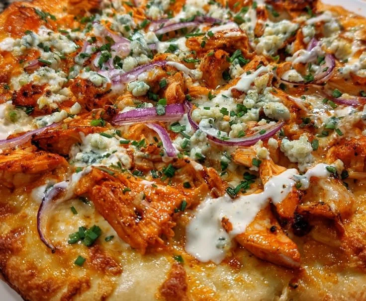 Delicious Buffalo Chicken Pizza topped with spicy chicken and cheese
