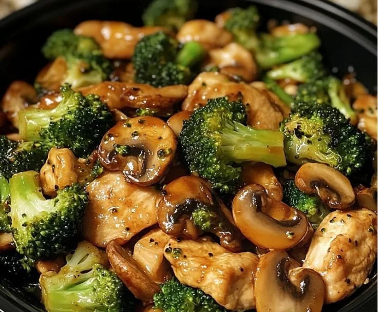 Delicious chicken broccoli mushroom stir-fry dish served in a colorful bowl.