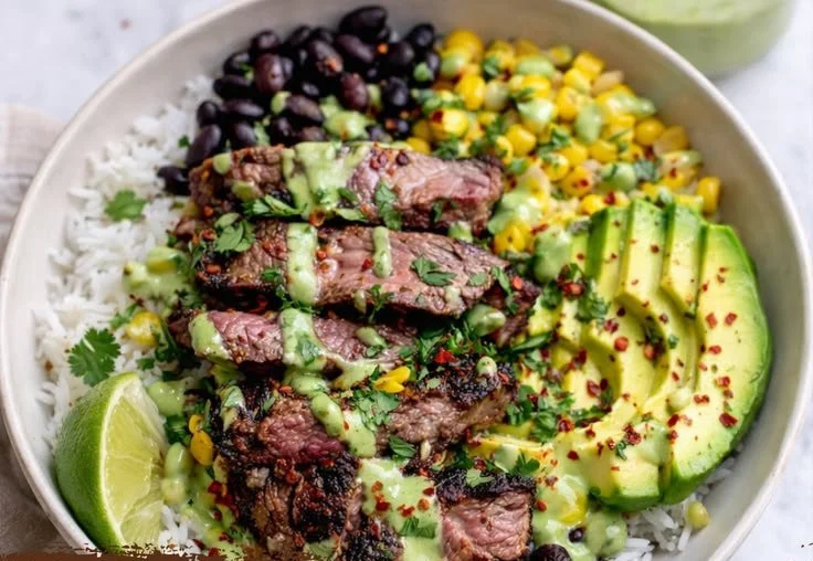 Cilantro lime steak rice bowls garnished with fresh cilantro and lime wedges