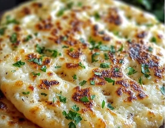 Delicious cottage cheese flatbread topped with fresh herbs and vegetables.