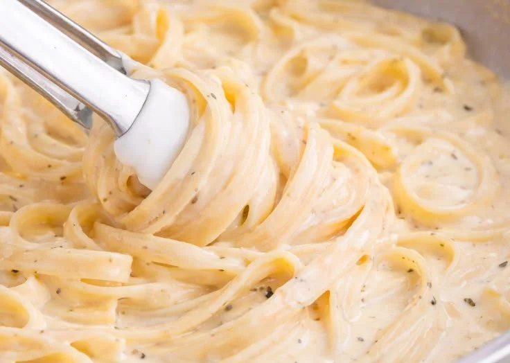 Homemade easy Alfredo sauce in a saucepan ready for pasta.