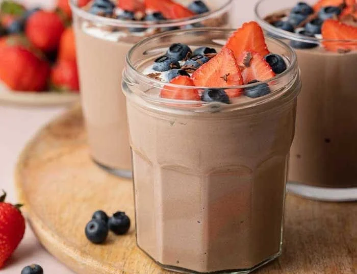 Bowl of easy chocolate protein pudding topped with chocolate shavings