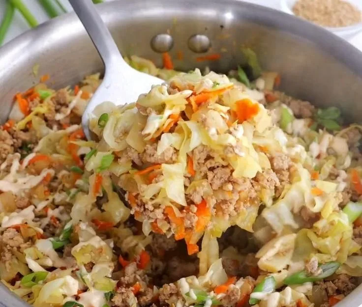 Healthy egg roll in a bowl ready to serve, with vegetables and meat mixed in a savory sauce.