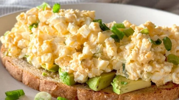 Egg salad made with cottage cheese, no mayo, garnished with fresh herbs.