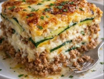 Ground turkey zucchini casserole in a baking dish, topped with cheese.