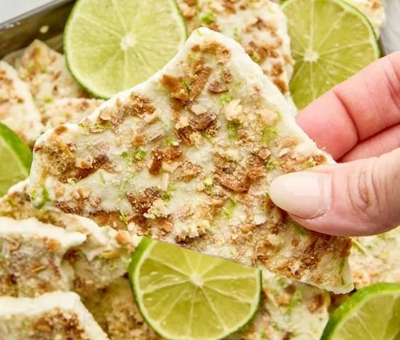 Homemade Key Lime Pie Yogurt Bark topped with crushed lime zest and coconut.