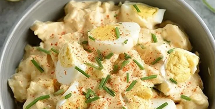 Low-carb Greek yogurt egg salad on a plate with fresh herbs