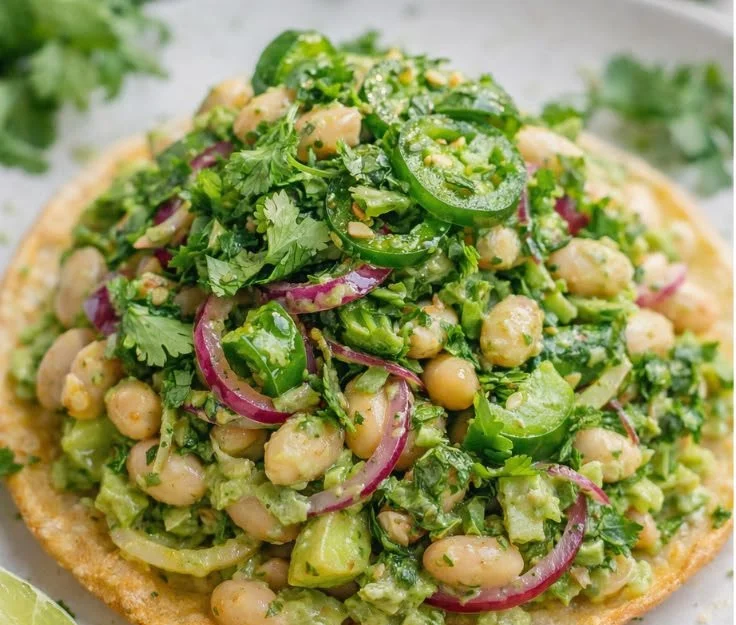 Marinated cilantro lime bean salad in a bowl with colorful vegetables