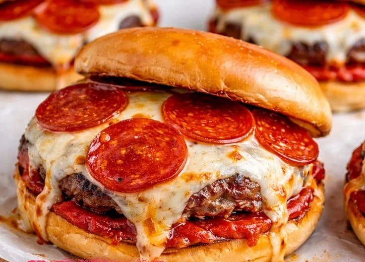 Delicious pizza burgers topped with cheese, pepperoni, and fresh ingredients.