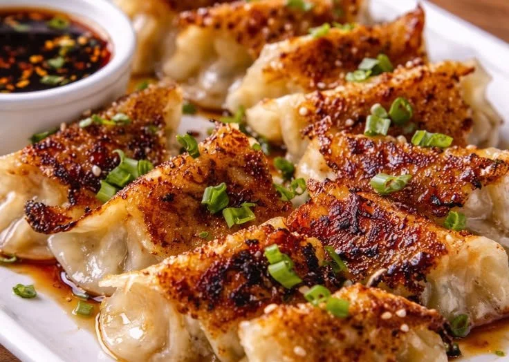Homemade Pork Potstickers served with dipping sauce on a plate