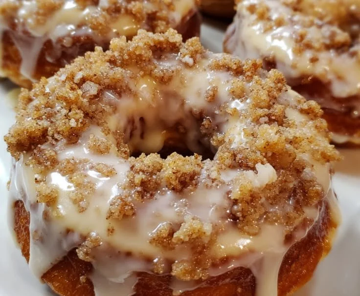 Vanilla-glazed baked coffee cake donuts fresh from the oven.