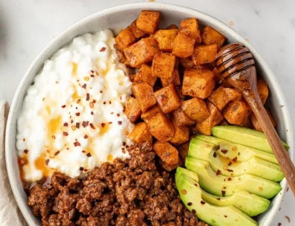 Delicious hot honey beef bowls topped with fresh vegetables and spices
