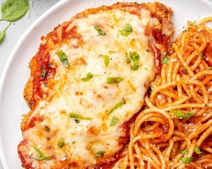 Delicious baked chicken parmesan served with marinara sauce and cheese