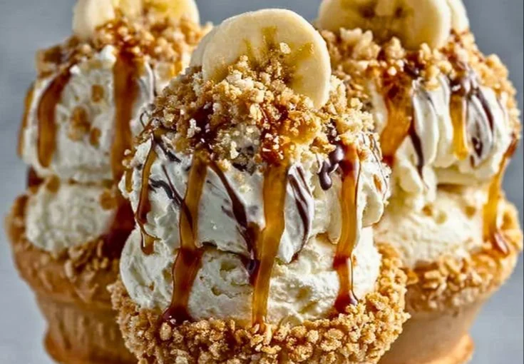 Banana pudding cheesecake cones topped with whipped cream and banana slices