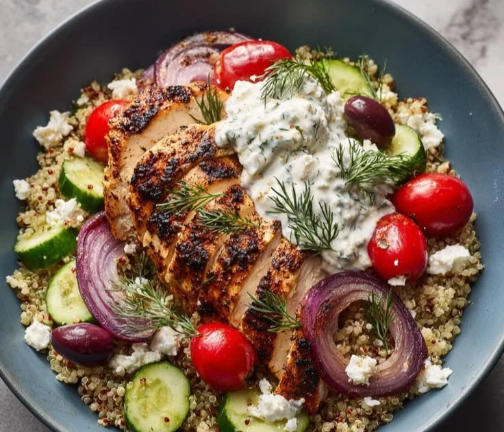 Bright Greek Chicken Bowls topped with fresh veggies and flavorful grilled chicken.