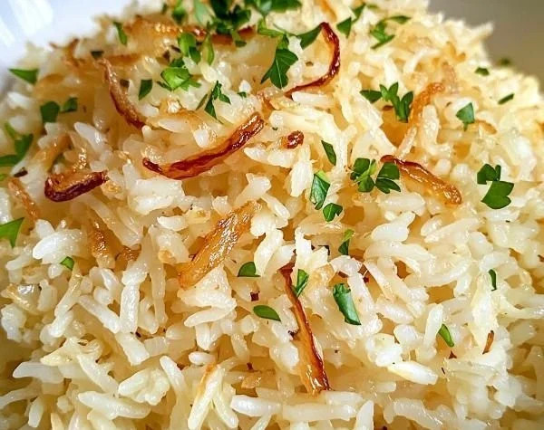 Delicious buttered jasmine rice with golden onion on a plate
