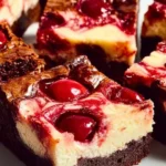Chocolate cherry cheesecake brownies with a rich creamy layer and cherry topping