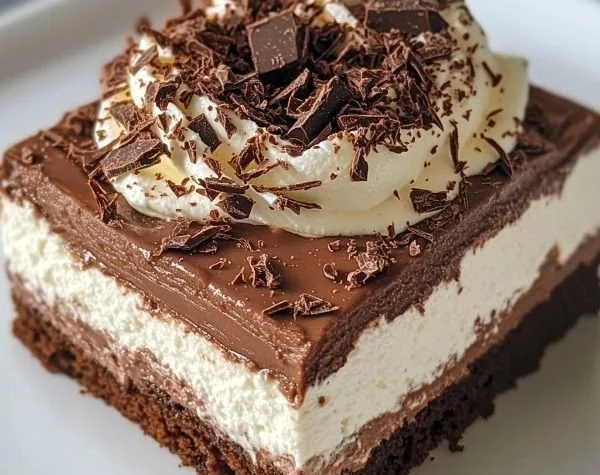 Chocolate cottage cheese mousse topped with whipped cream and chocolate shavings