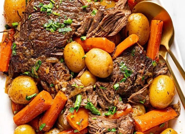 Delicious easy crock pot pot roast with gravy served on a plate.