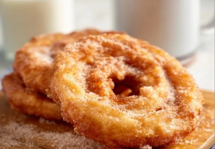 Delicious fried cinnamon apple rings served on a plate