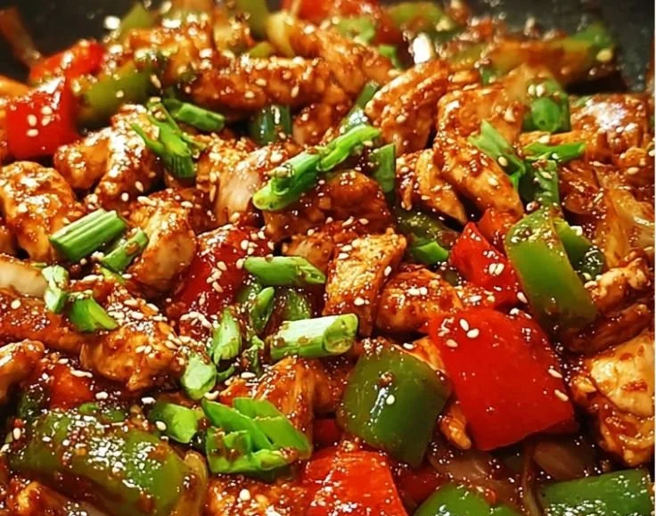 Korean spicy chicken stir fry with colorful vegetables and spices