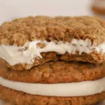 Homemade oatmeal cream pies with fluffy cream filling between chewy cookies.