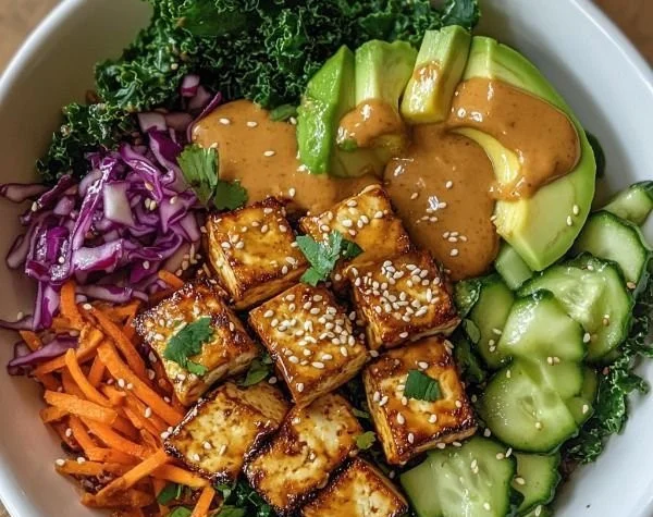 Peanut Sauce Tofu Buddha Bowl with fresh vegetables and grains