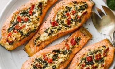 Stuffed salmon fillet with spinach and feta cheese on a plate