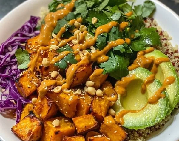 Colorful Thai Peanut Buddha Bowl with sweet potatoes and fresh vegetables